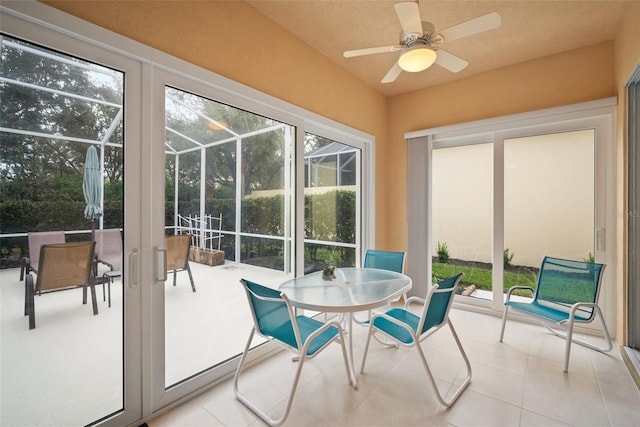 sunroom / solarium featuring ceiling fan