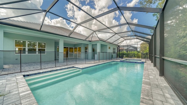 view of swimming pool featuring a patio and a lanai