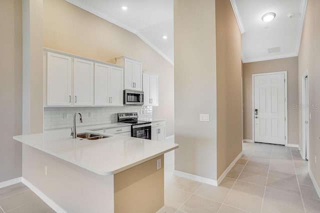 kitchen with kitchen peninsula, stainless steel appliances, sink, white cabinets, and lofted ceiling