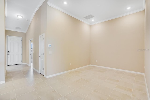 tiled empty room featuring crown molding