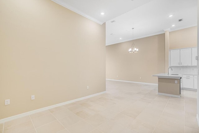 interior space featuring sink, light tile patterned flooring, a chandelier, and ornamental molding