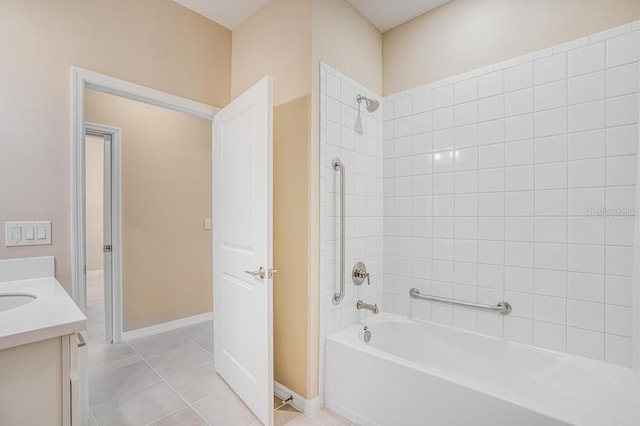 bathroom featuring vanity, tiled shower / bath combo, and tile patterned flooring