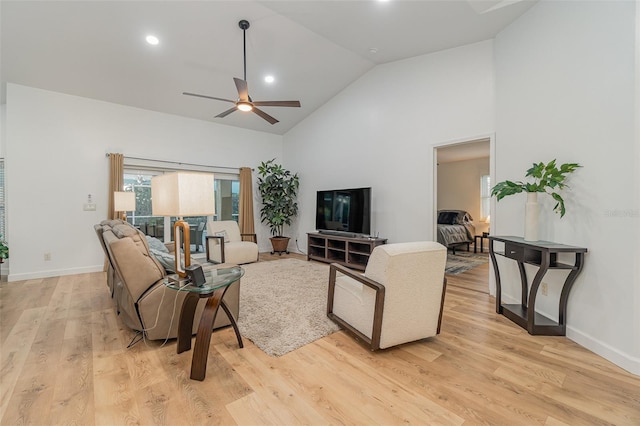 living room featuring high vaulted ceiling, light wood-type flooring, and ceiling fan