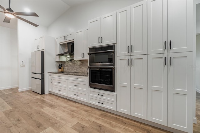 kitchen featuring ceiling fan, light hardwood / wood-style flooring, wall chimney range hood, white cabinetry, and black appliances