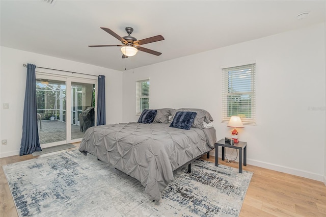 bedroom featuring ceiling fan, light wood-type flooring, and access to exterior