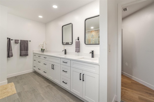 bathroom featuring vanity and hardwood / wood-style flooring