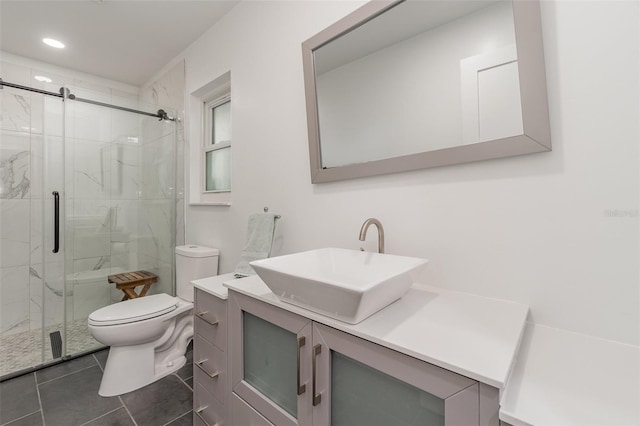 bathroom featuring vanity, toilet, a shower with door, and tile patterned floors