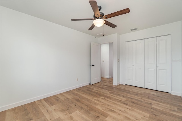 unfurnished bedroom featuring light hardwood / wood-style flooring, a closet, and ceiling fan