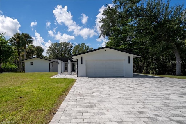 view of front of property with a garage and a front yard