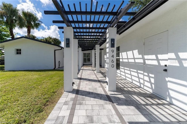 exterior space featuring a lawn, a pergola, and a patio area