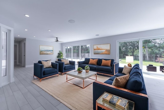 living room with ceiling fan and light hardwood / wood-style flooring