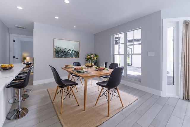 dining space with light hardwood / wood-style flooring