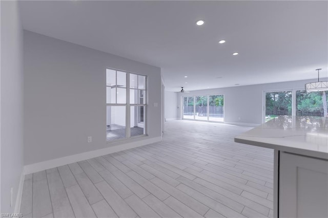 interior space with ceiling fan and light hardwood / wood-style floors