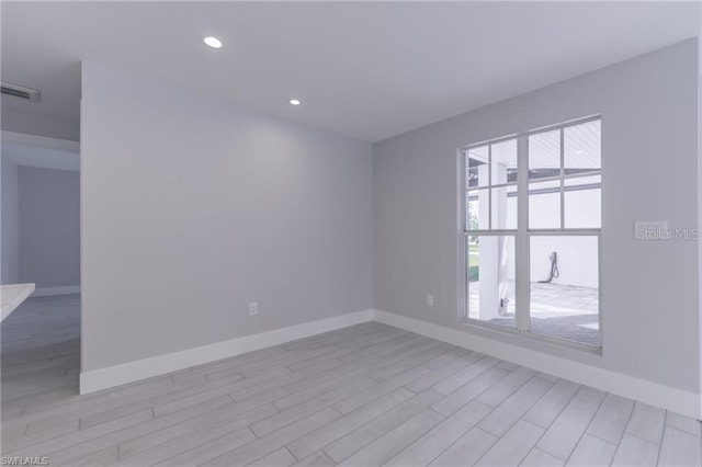 unfurnished room with light hardwood / wood-style floors