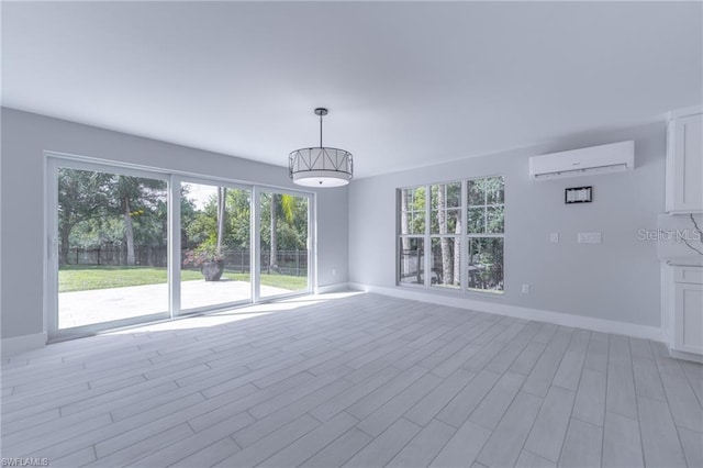 empty room featuring light hardwood / wood-style flooring and an AC wall unit