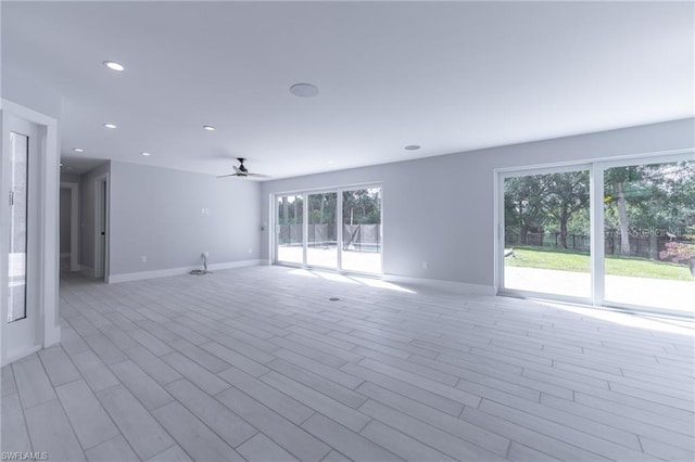 spare room with ceiling fan and light hardwood / wood-style floors