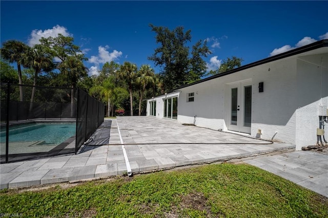 view of pool with a patio and french doors