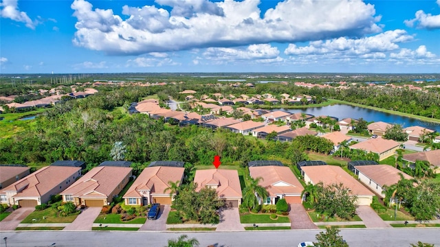 birds eye view of property with a water view