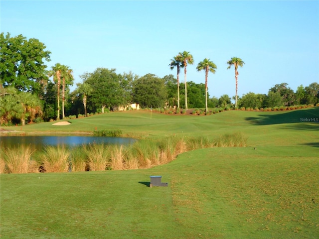 view of home's community featuring a water view and a yard