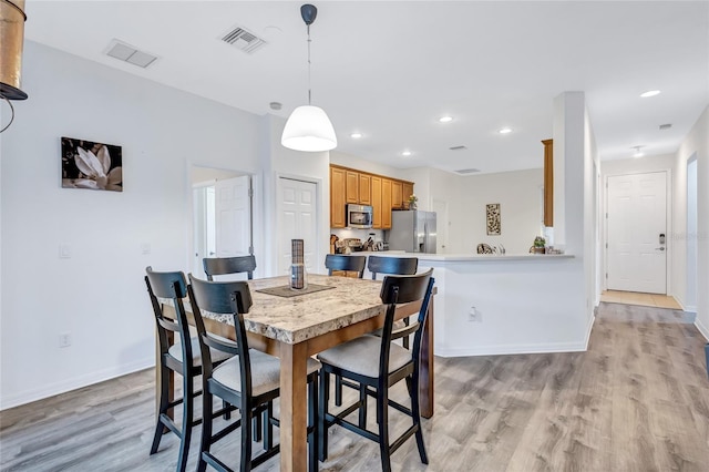 dining room with light wood-type flooring