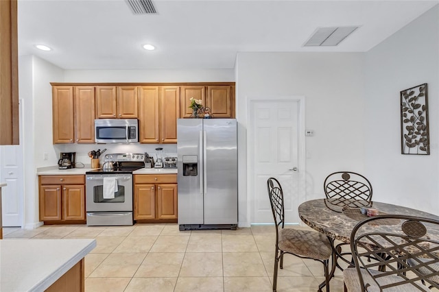 kitchen with appliances with stainless steel finishes and light tile patterned flooring