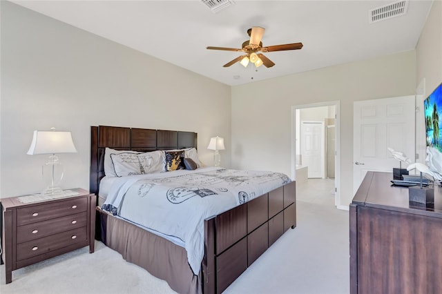 bedroom featuring ceiling fan, ensuite bathroom, and light carpet