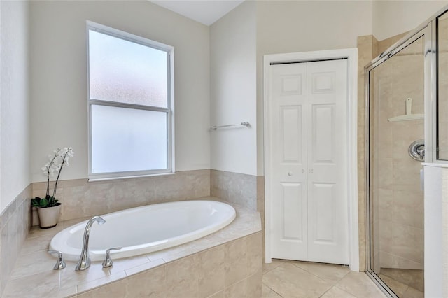 bathroom featuring tile patterned floors and shower with separate bathtub