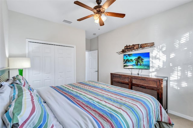 bedroom featuring ceiling fan, a closet, and carpet