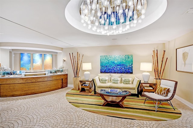 carpeted living room featuring a notable chandelier