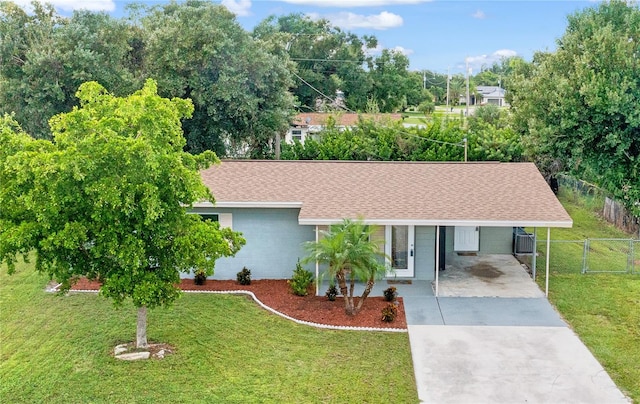 single story home featuring a front lawn and a carport