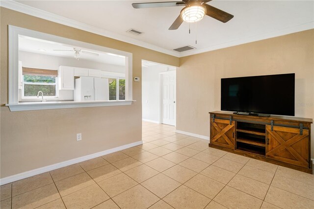 unfurnished living room with ornamental molding, ceiling fan, and light tile patterned floors