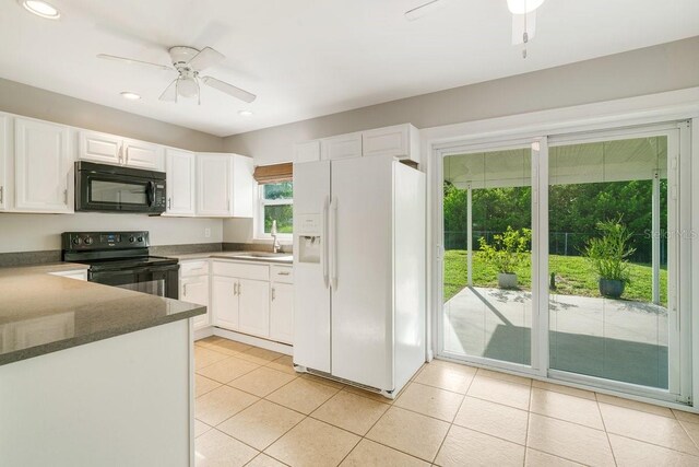 kitchen featuring ceiling fan, light tile patterned flooring, sink, white cabinetry, and black appliances