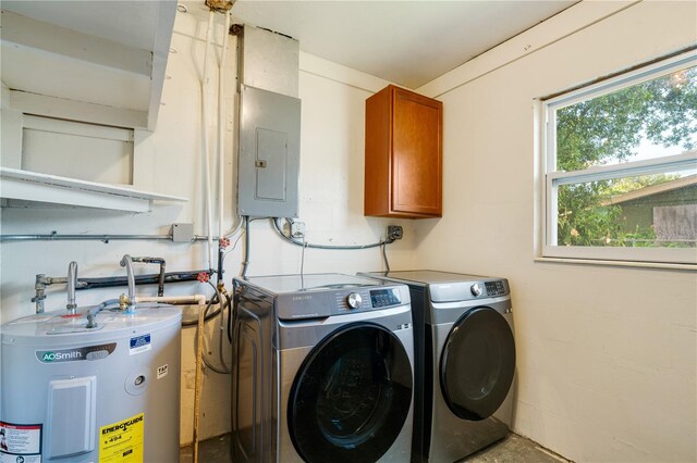 clothes washing area featuring cabinets, electric water heater, electric panel, and independent washer and dryer