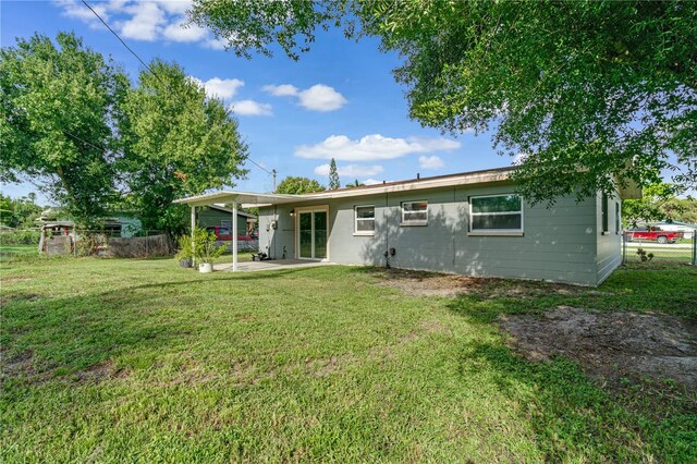 rear view of house with a patio area and a yard