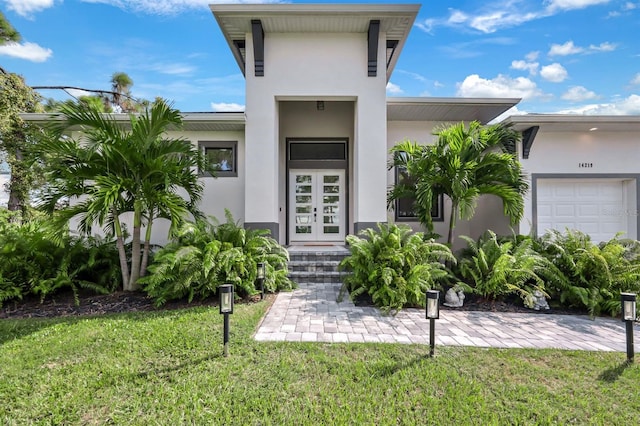 entrance to property with a yard and a garage