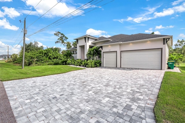 view of front facade with a garage and a front lawn