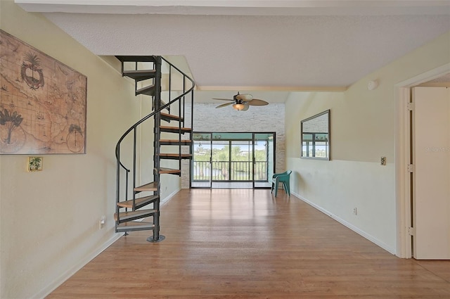 1026 Bird Bay Way Unit 276, Venice, FL 34285 - unfurnished living room with stairway, wood finished floors, ceiling fan, and baseboards