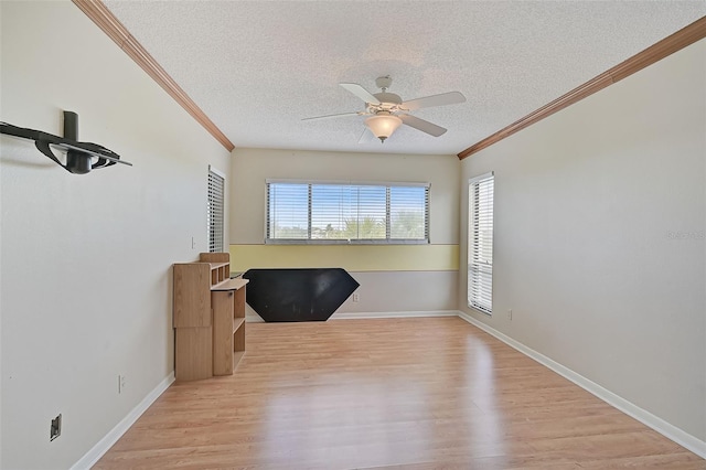 1026 Bird Bay Way Unit 276, Venice, FL 34285 - unfurnished office with a textured ceiling, ornamental molding, wood finished floors, a ceiling fan, and baseboards