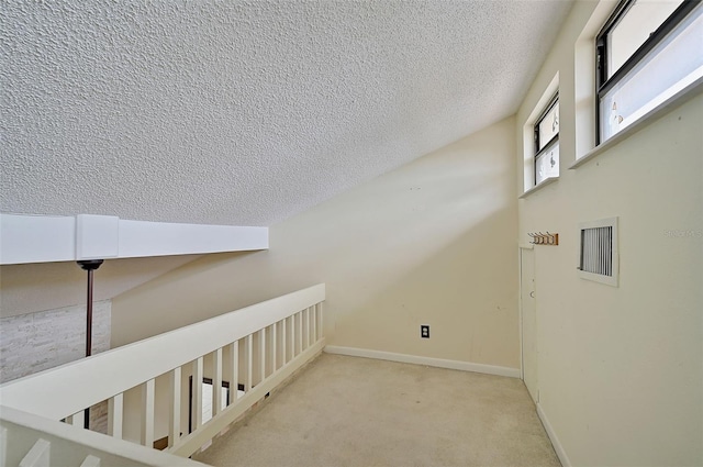 1026 Bird Bay Way Unit 276, Venice, FL 34285 - hall featuring a textured ceiling, carpet flooring, and baseboards