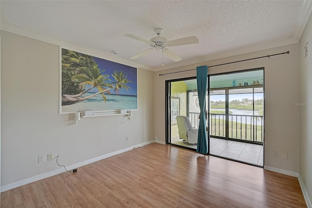 1026 Bird Bay Way Unit 276, Venice, FL 34285 - spare room featuring wood finished floors, ceiling fan, ornamental molding, baseboards, and a textured ceiling