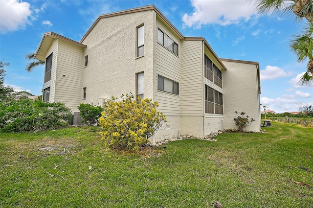 1026 Bird Bay Way Unit 276, Venice, FL 34285 - view of property exterior with a yard and stucco siding