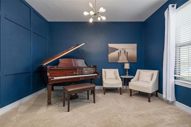 sitting room featuring a notable chandelier, a textured ceiling, and light colored carpet