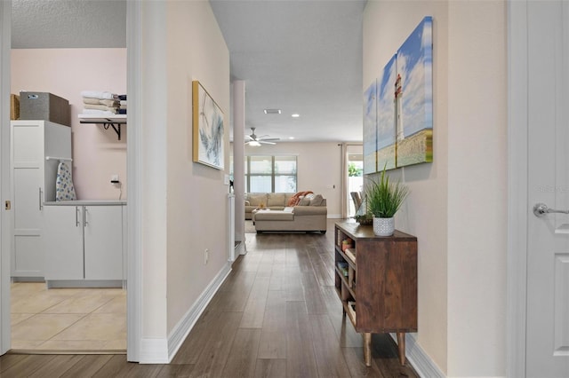 hallway featuring a textured ceiling and hardwood / wood-style floors