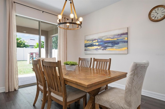 dining space featuring dark hardwood / wood-style flooring and a chandelier