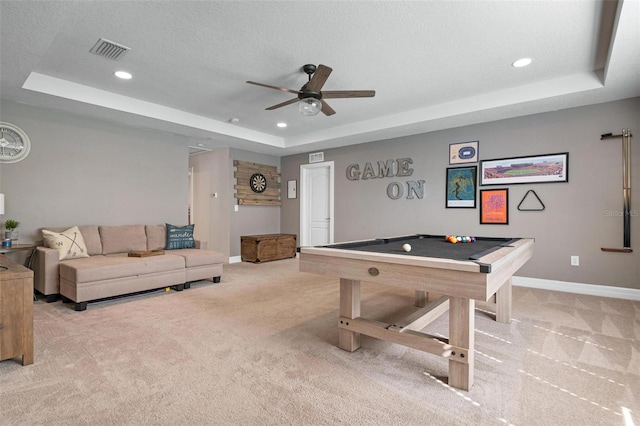 recreation room featuring a tray ceiling, ceiling fan, pool table, and light colored carpet