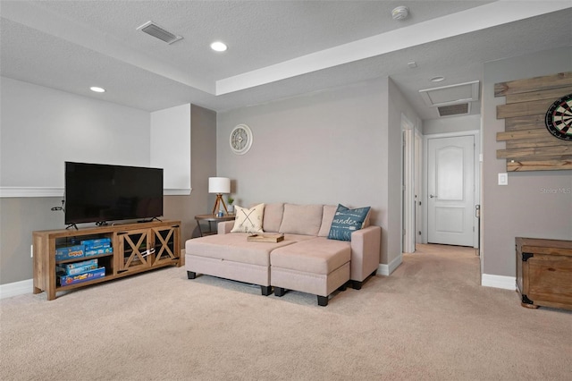 carpeted living room featuring a textured ceiling