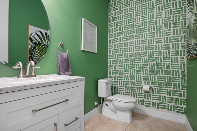 bathroom with tile patterned flooring, vanity, and toilet