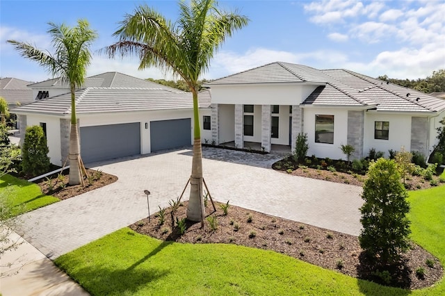 view of front of home featuring a garage and a front lawn