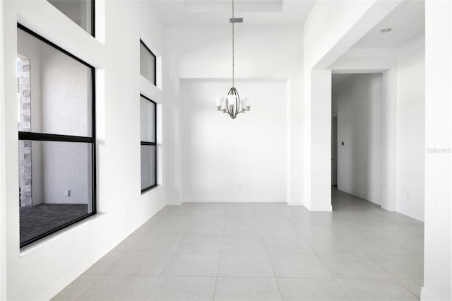 unfurnished room with an inviting chandelier, a high ceiling, and light tile patterned flooring