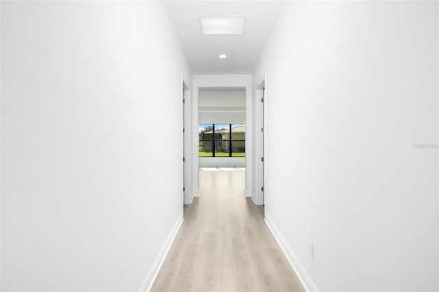 corridor with light hardwood / wood-style flooring